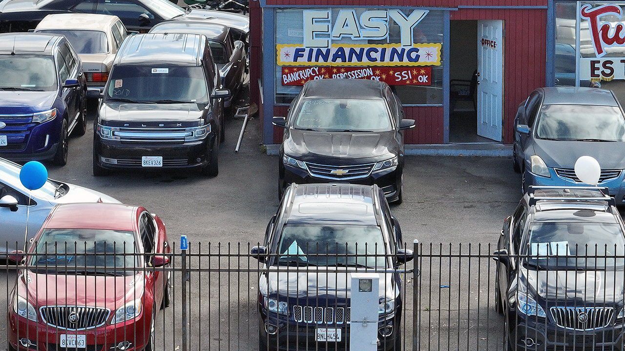 A poster advertising “easy financing” in a used car lot